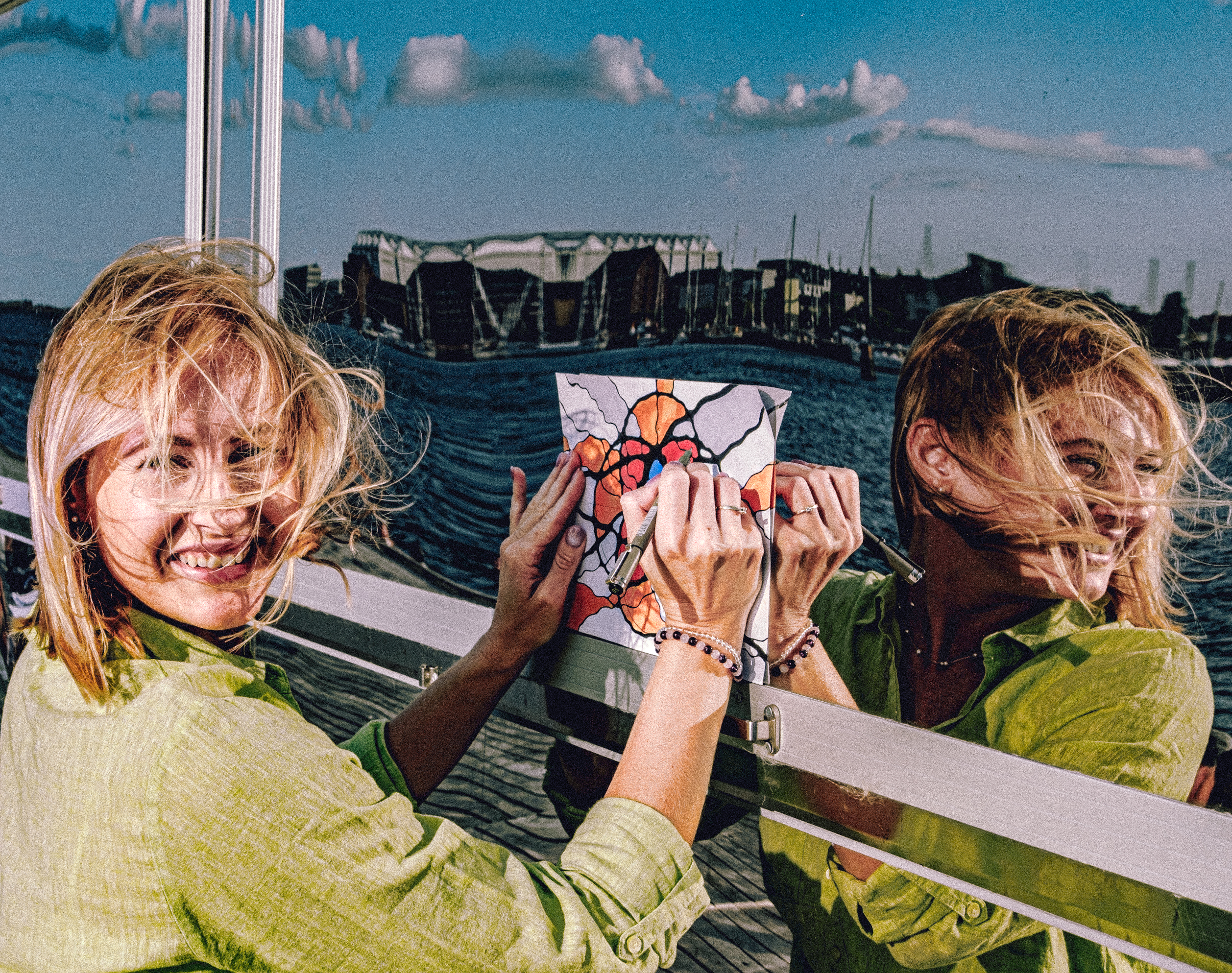 Woman drawing a mindful neurocreative artwork on a mirror reflection outdoors to support emotional clarity and stress relief